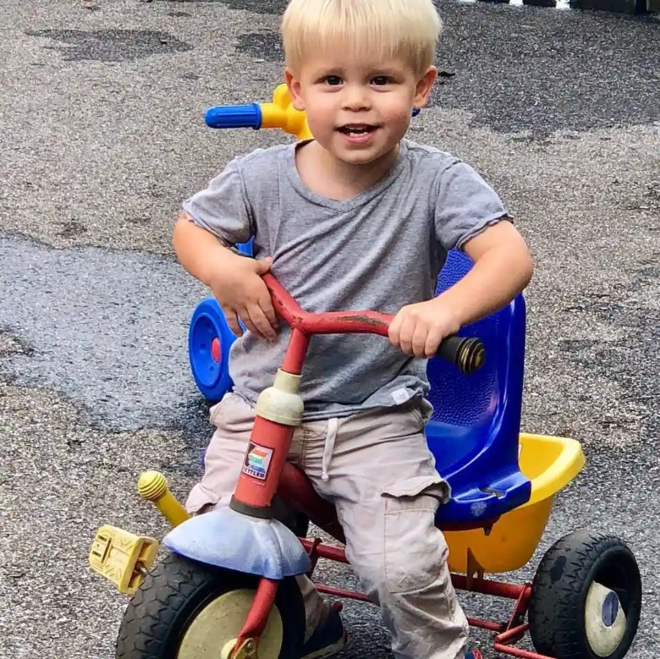 A kid riding a tricycle